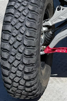 Close-up of a rugged off-road tire on a vehicle.