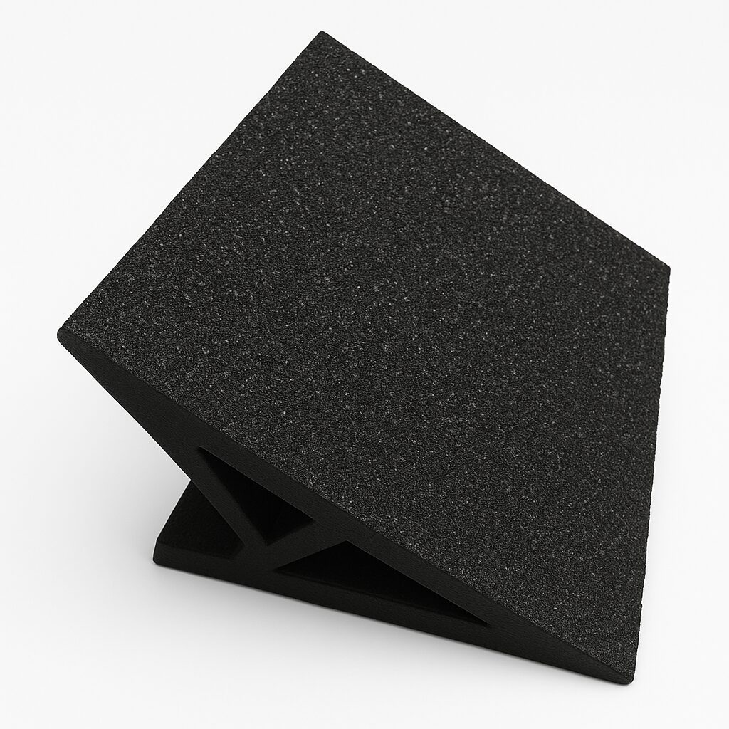 Black acoustic foam panel with a wedge pattern.