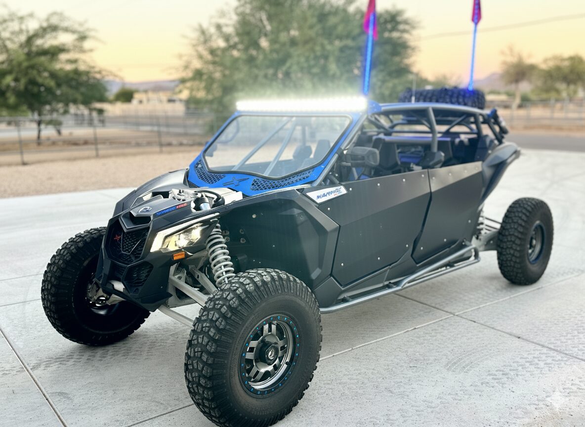 A rugged off-road vehicle parked on a concrete surface near a fence.